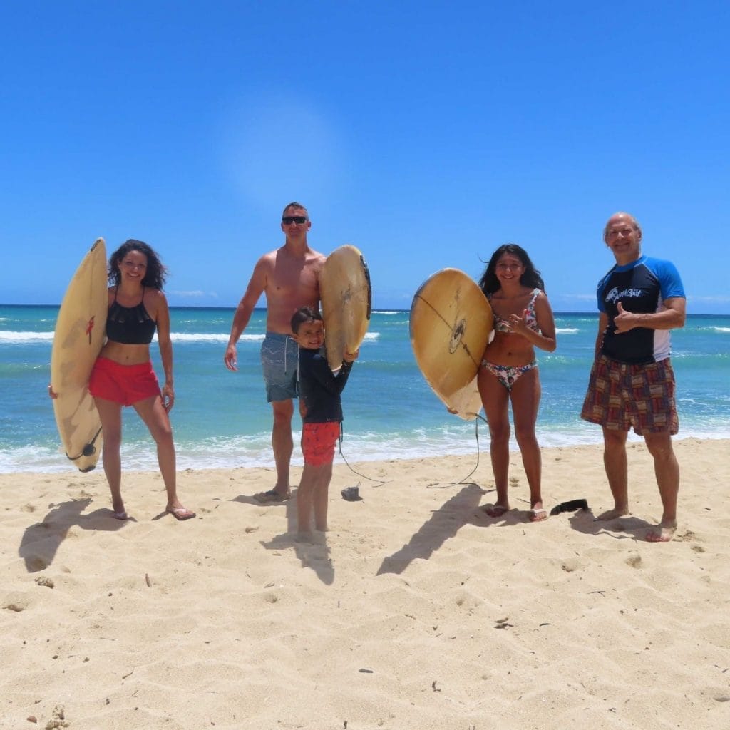 This image shows Doug Nordman and the Baughier's surfing on White Plains Beach on Oahu